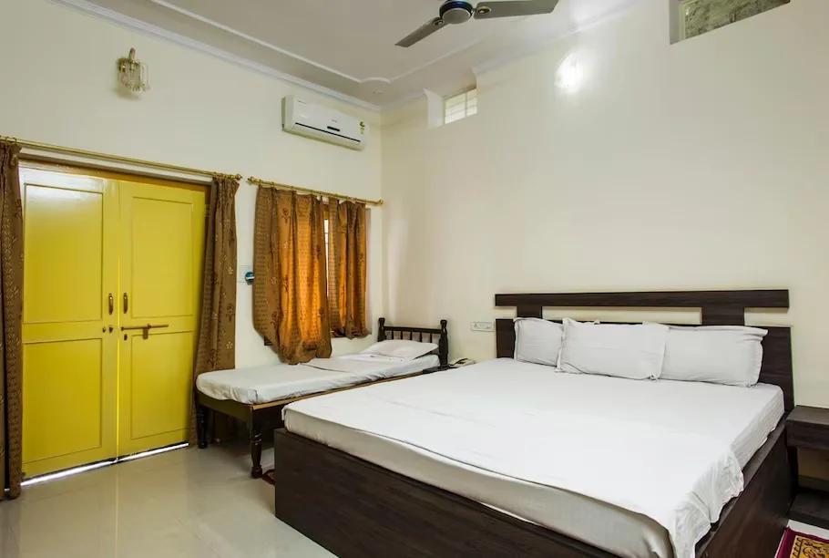 two single bed in one room at staybook hotel vatika in Ranthambore hotel_Image