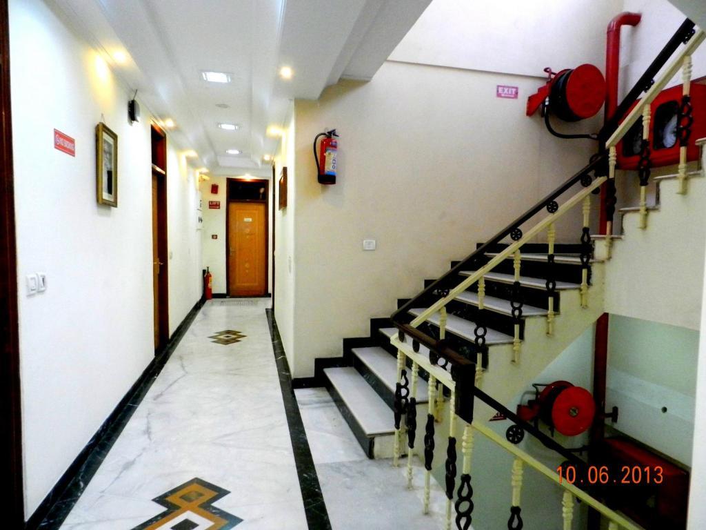 a hallway with wooden door in a building and stairs at hotel tara palace chandni chowk in New Delhi hotel_Image