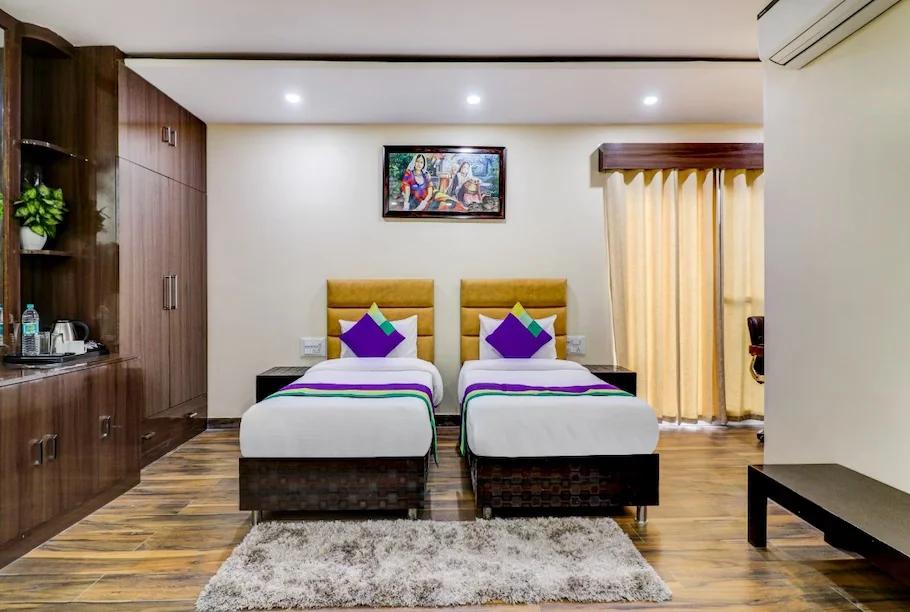 a bedroom with two bed and a sofa at hotel green earth in Gurugram hotel_Image