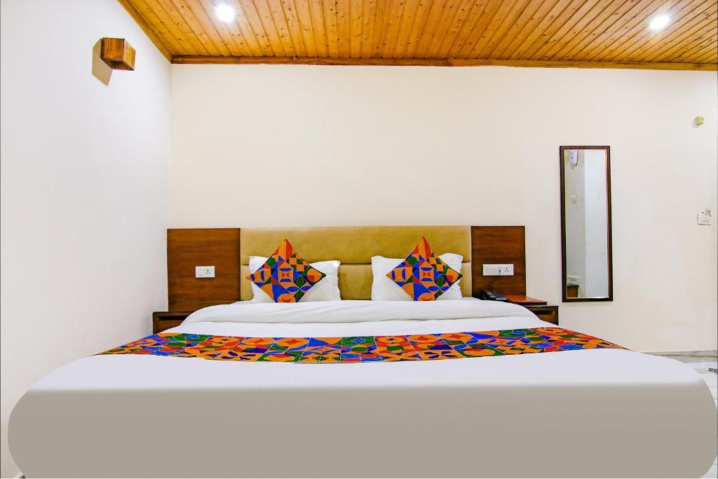a bedroom with a mirror at hotel kanari in Mussoorie hotel_Image