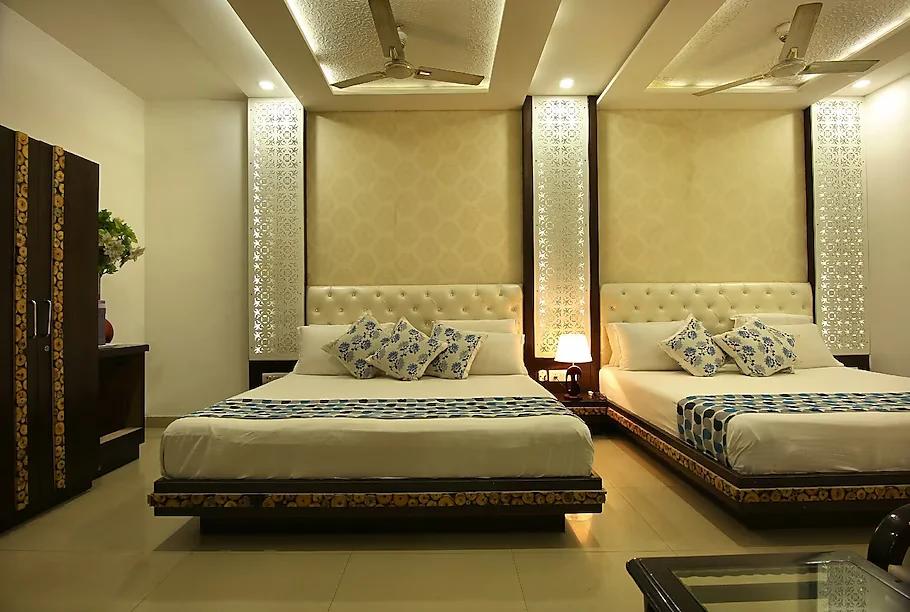 a two double bed room with t.v at hotel riya palace in agra hotel_Image
