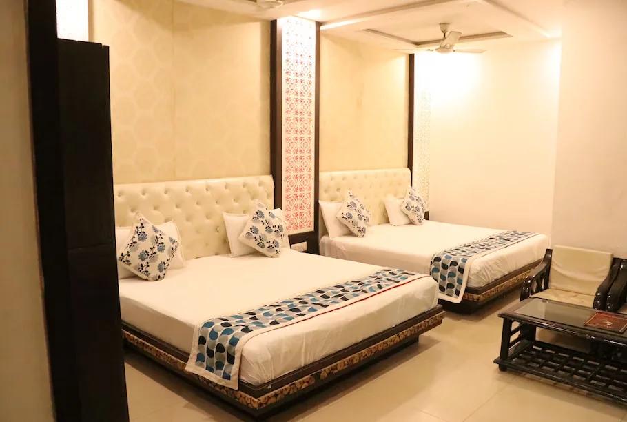 a two double bed room with t.v at hotel riya palace in agra hotel_Image