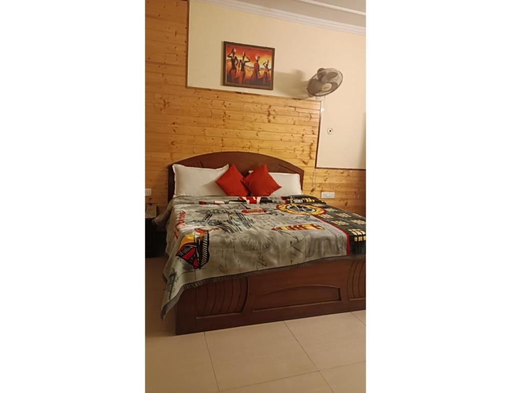a bedroom with a large bed and a sofa at staybook hotel usha palace in Mussoorie hotel_Image
