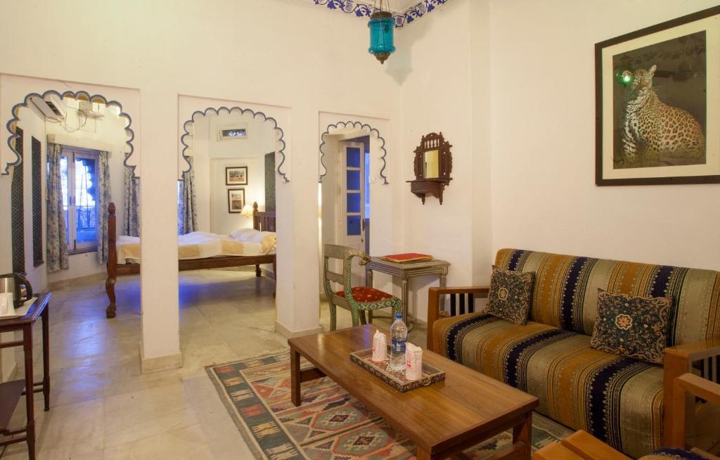a sofa and one table at lake pichola hotel in udaipur hotel_Image