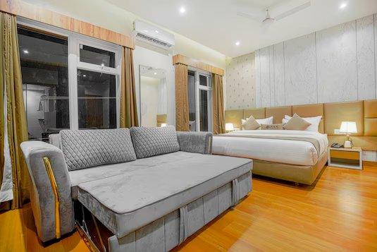 a bedroom with a sofa and a ac at mm hotel in chandigarh hotel_Image