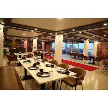 a dinner area with chairs and table at mm hotel in mussoorie hotel_Image