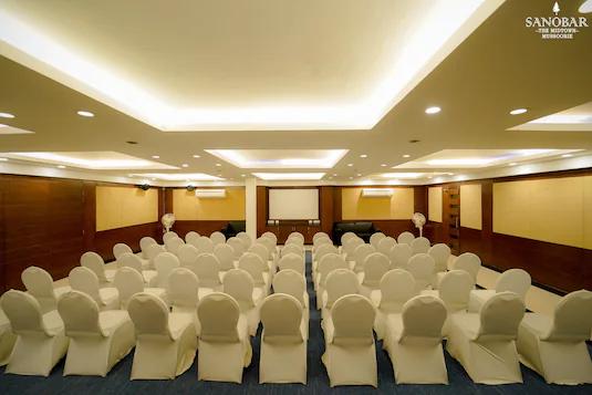 a hall area with chairs and a white board at sanobar the midtown hotel in mussoorie hotel_Image