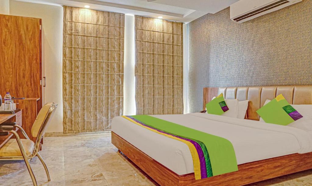 a bedroom with white bedsit at sanskar prime hotel in jaipur hotel_Image