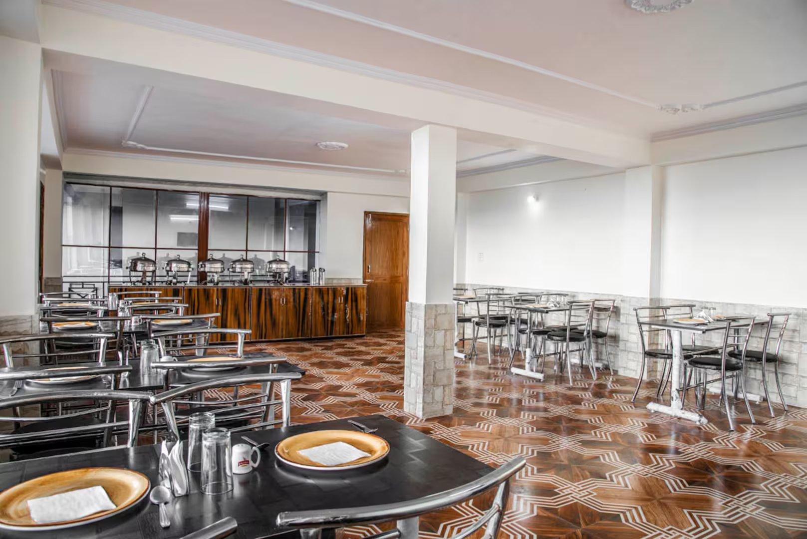 a dinner area with chairs and table at shimla nature ville in shimla hotel_Image