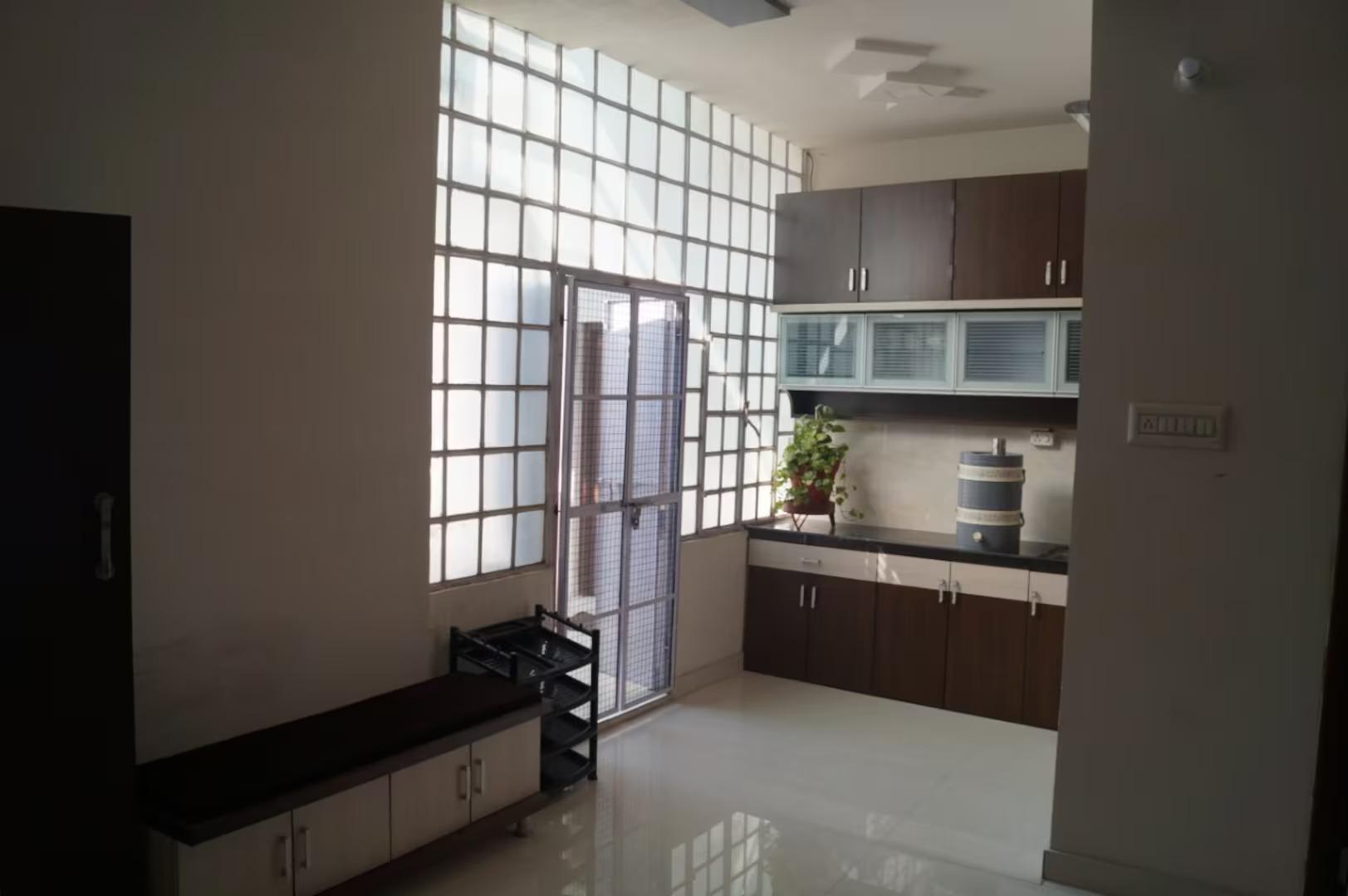 a kitchen view with table at stayvillas shastrinagar in jodhpur hotel_Image