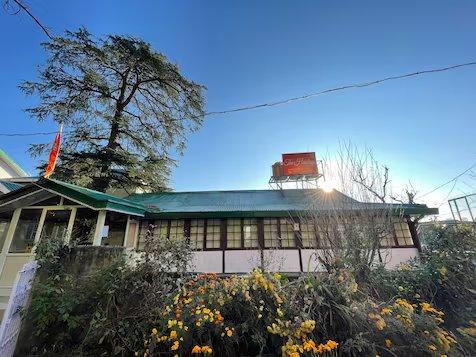 a hotel with nature view and front view of hotel at the haritage hotel in shimla hotel_Image